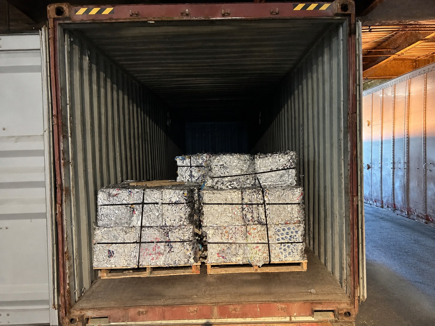 Foil bales loaded upright inside an export container