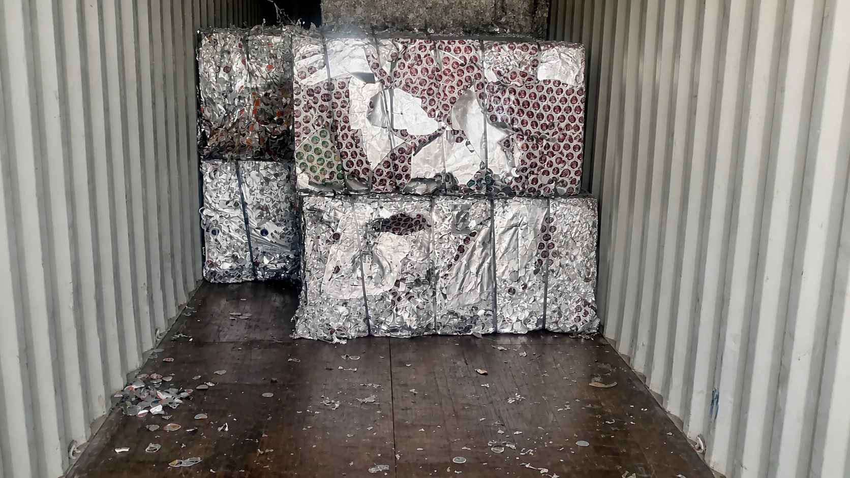 Recovered aluminum foil bales staged inside a shipping container